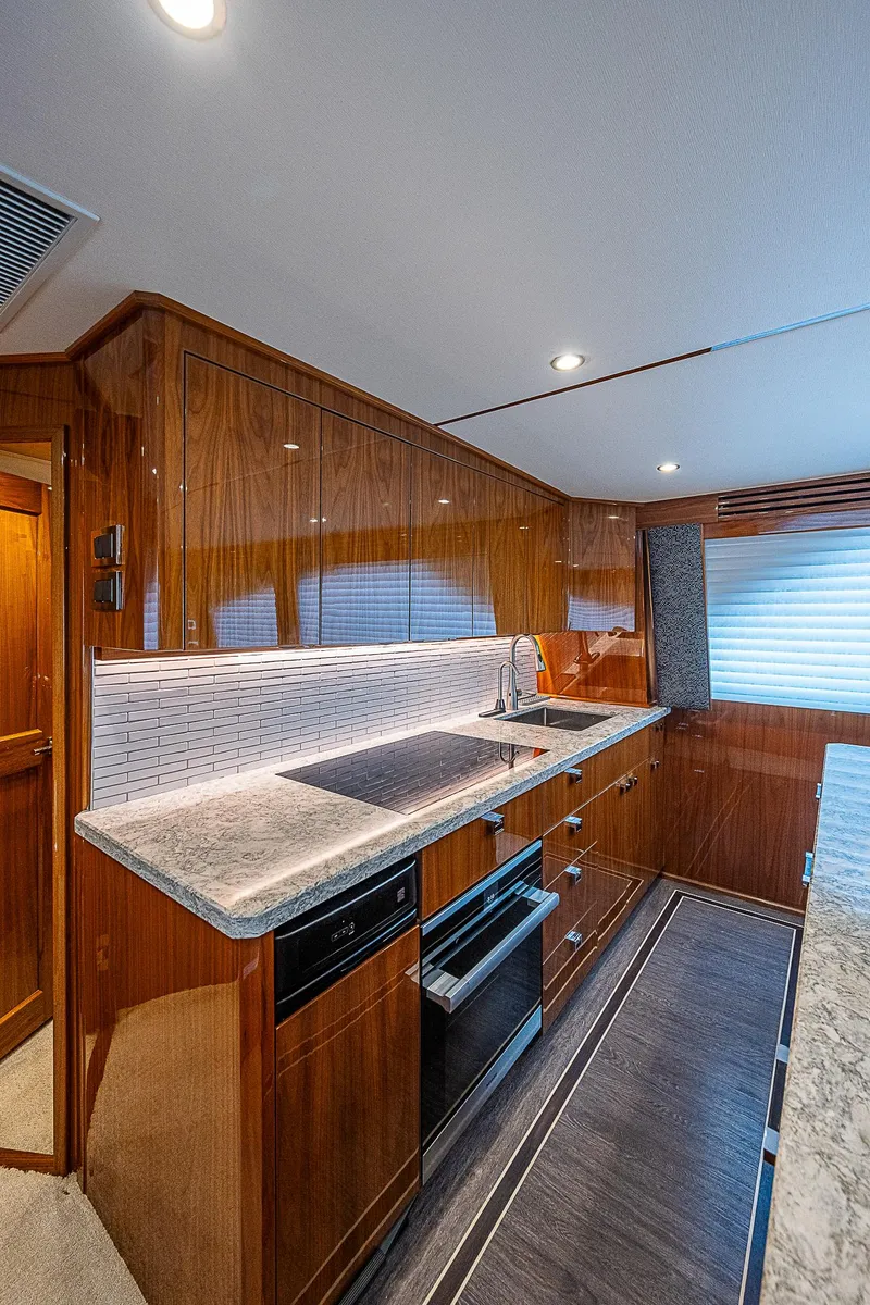 Slide: The Image of Modern kitchen in 2020 Viking 68 Convertible yacht with sleek wood cabinetry. - 28