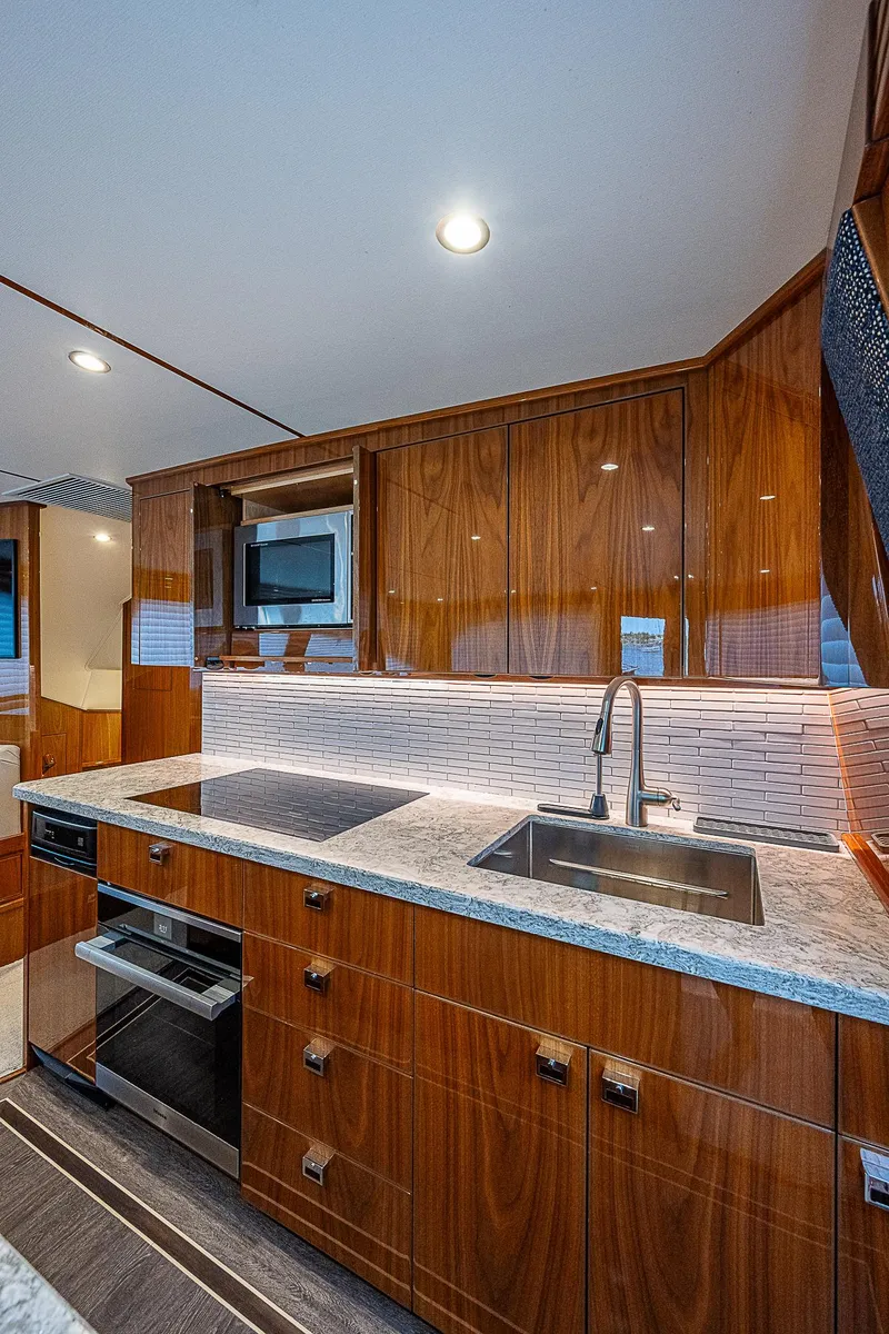 Slide: The Image of Modern kitchen in 2020 Viking 68 Convertible yacht with sleek wood cabinetry. - 30
