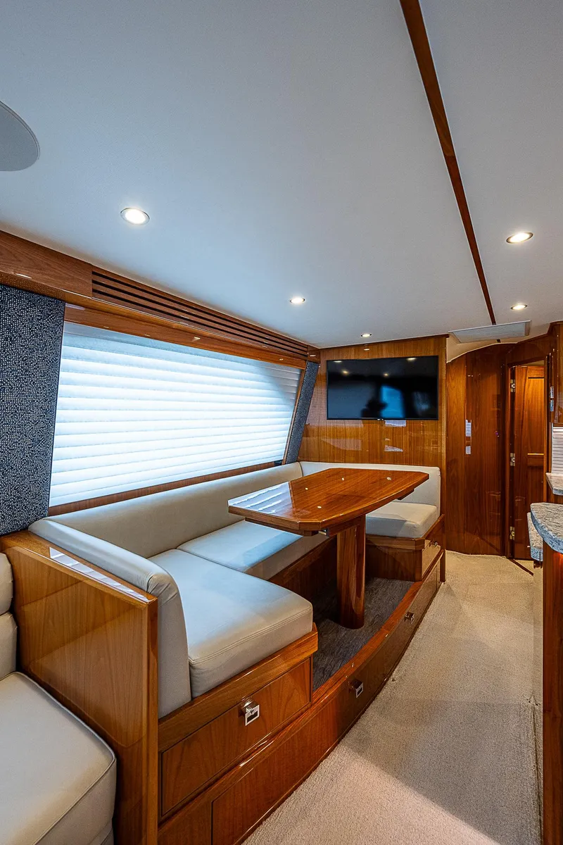 Slide: The Image of Interior of 2020 Viking 68 Convertible yacht with dining area and TV. - 32