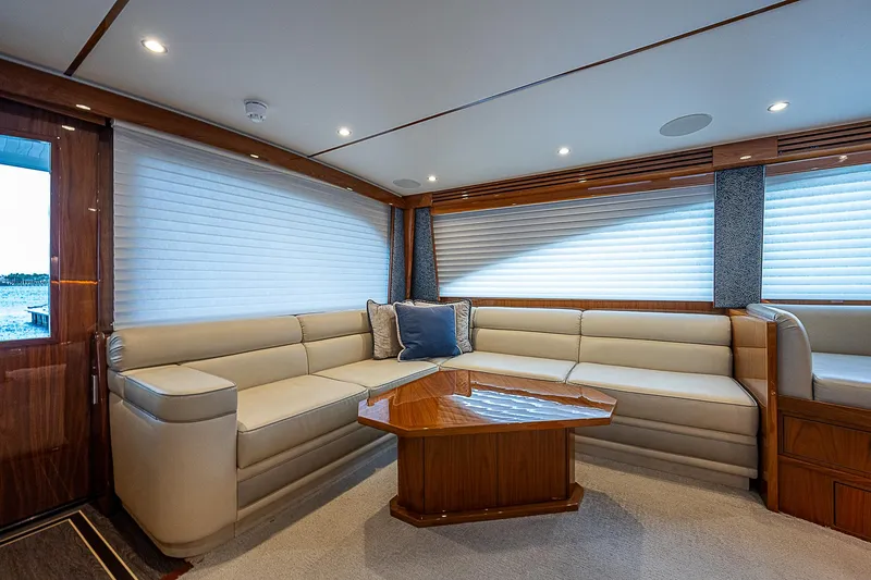 Slide: The Image of Luxurious interior of 2020 Viking 68 Convertible yacht with plush seating and wooden table. - 39