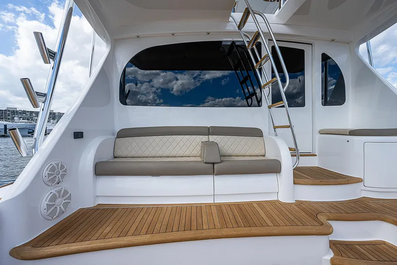 Slide: The Image of 2020 Viking 68 Convertible yacht with teak deck and cushioned seating. - 4