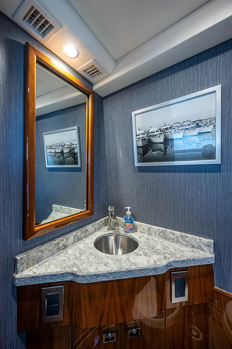 Slide: The Image of 2020 Viking 68 Convertible yacht bathroom with modern sink and mirror. - 40