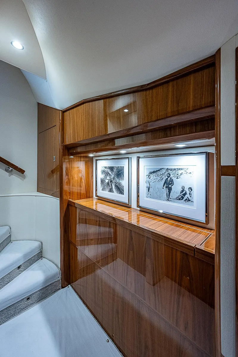 Slide: The Image of 2020 Viking 68 Convertible yacht interior with wooden cabinetry and framed artwork. - 42