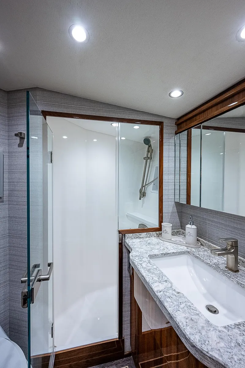 Slide: The Image of Modern bathroom in 2020 Viking 68 Convertible yacht with glass shower and granite countertop. - 44