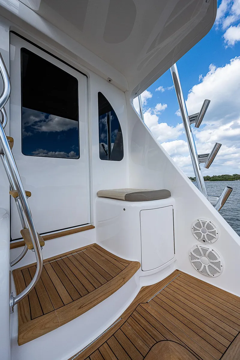 Slide: The Image of 2020 Viking 68 Convertible yacht deck with wooden steps and seating. - 5
