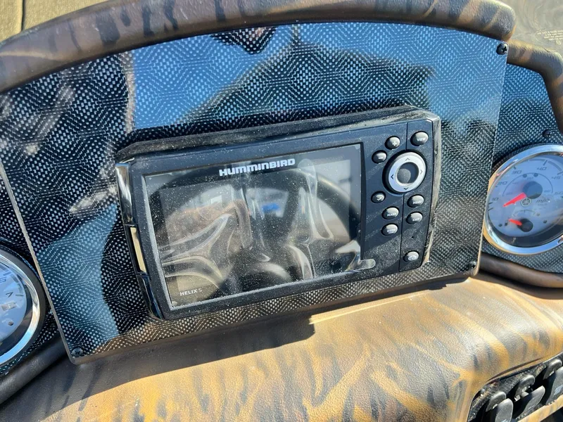 Slide: The Image of 2024 G3 Sportsman 1710 VYL dashboard with Humminbird Helix 5 fish finder and gauges. - 15