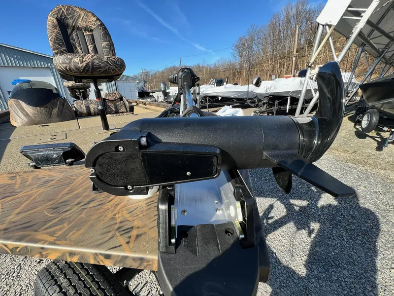 Slide: The Image of 2024 G3 Sportsman 1710 VYL boat with camo seats and motor, parked outdoors. - 23