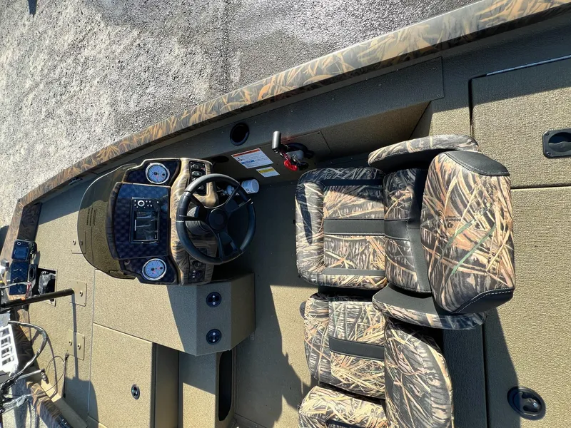 Slide: The Image of 2024 G3 Sportsman 1710 VYL boat interior with camo seats and steering console. - 25