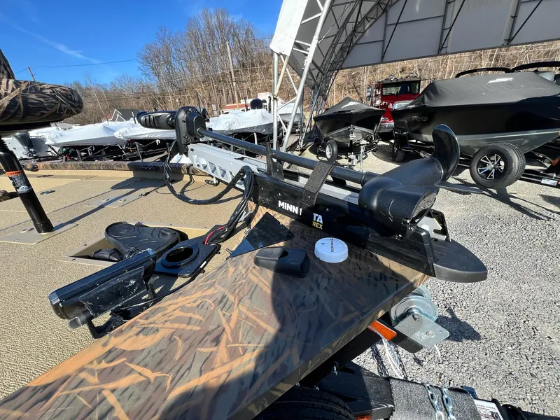 Slide: The Image of 2024 G3 Sportsman 1710 VYL boat with Minn Kota trolling motor in a dealership lot. - 33