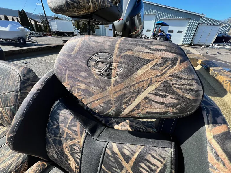 Slide: The Image of Camouflage seats of the 2024 G3 Sportsman 1710 VYL boat in a marina. - 35