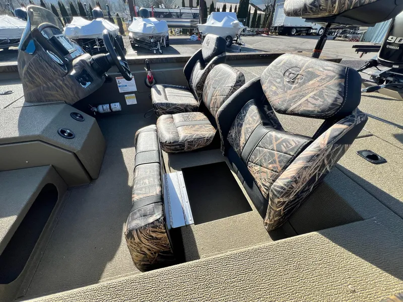 Slide: The Image of 2024 G3 Sportsman 1710 VYL boat interior with camo-patterned seats and steering console. - 36