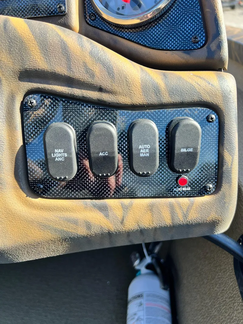 Slide: The Image of Control panel of 2024 G3 Sportsman 1710 VYL boat with switches and fire extinguisher. - 7