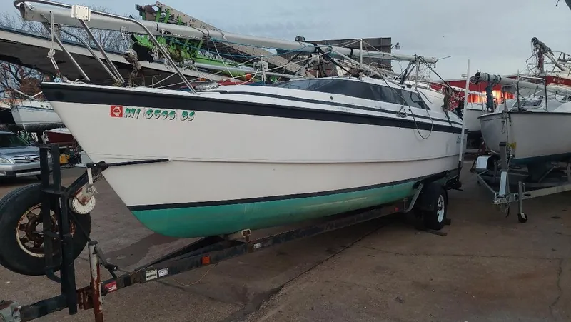 The Image of 1996 MacGregor 26 "X" sailboat on trailer, parked outdoors. - 0