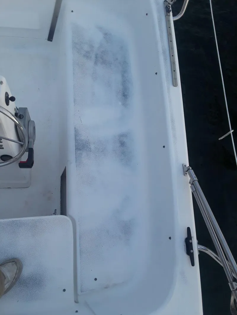 Slide: The Image of 1996 MacGregor 26 "X" sailboat cockpit with steering wheel and seating area. - 12