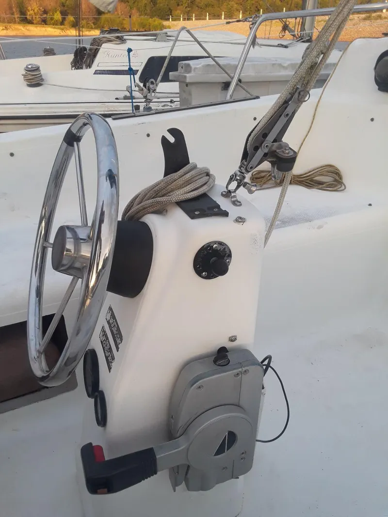 Slide: The Image of Steering console of a 1996 MacGregor 26 "X" sailboat with ropes and controls. - 16