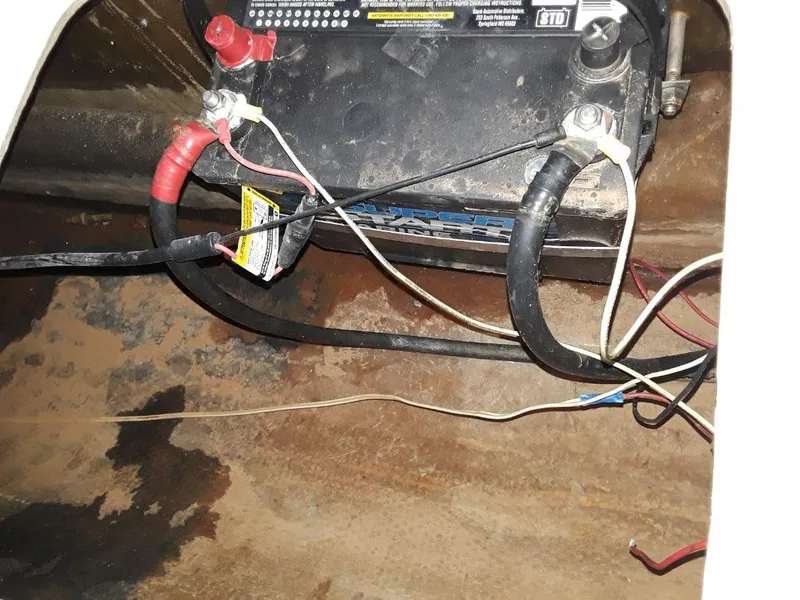Slide: The Image of Battery compartment of a 1996 MacGregor 26 "X" sailboat with visible wiring. - 42