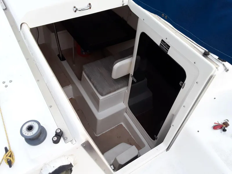 Slide: The Image of 1996 MacGregor 26 "X" sailboat cabin entrance with steps and seating. - 5