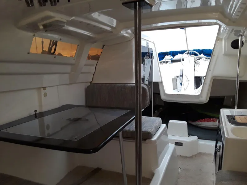 Slide: The Image of Interior of a 1996 MacGregor 26 "X" sailboat with seating and table. - 6