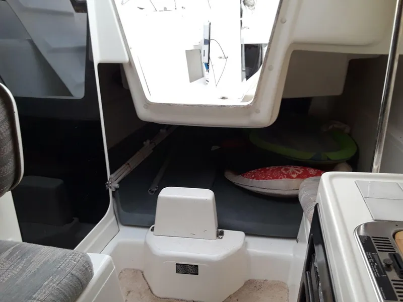 Slide: The Image of Interior of a 1996 MacGregor 26 "X" sailboat, showing cabin and seating area. - 7