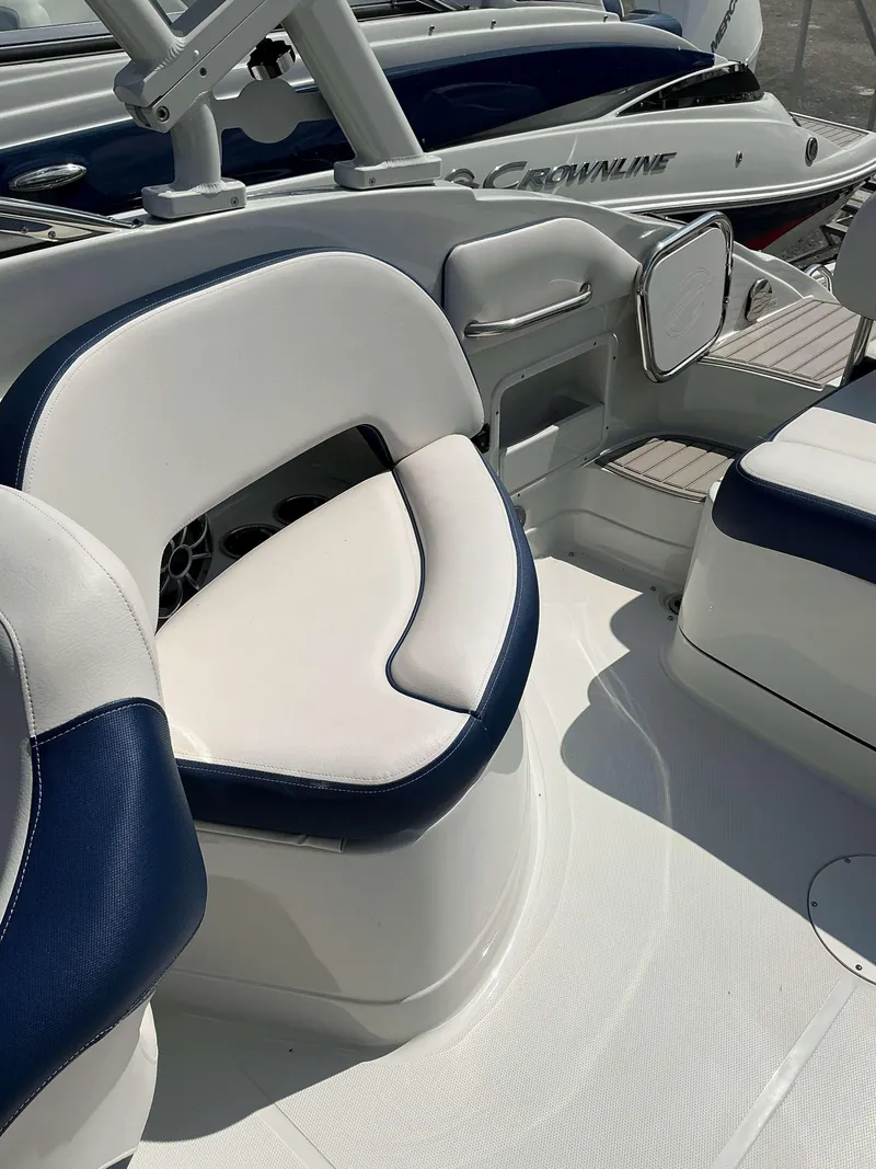 Slide: The Image of 2024 Crownline 260XSS boat interior with white and blue seating. - 11