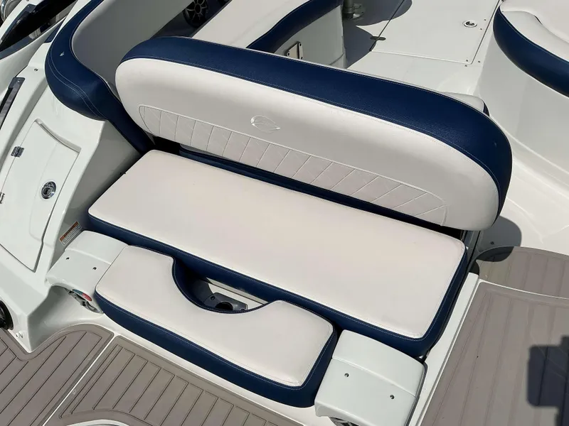 Slide: The Image of 2024 Crownline 260XSS boat seating with blue and white upholstery. - 17
