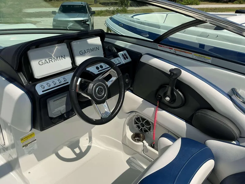 Slide: The Image of 2024 Crownline 260XSS boat cockpit with Garmin displays and modern steering wheel. - 8
