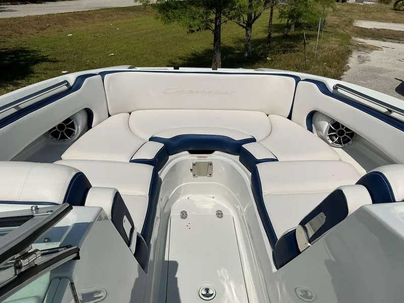 Slide: The Image of 2024 Crownline 260XSS boat interior with white and blue seating, outdoor setting. - 9