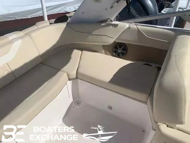 Slide: The Image of Interior seating of a 2018 Regal OBX boat, featuring beige upholstery and spacious layout. - 5