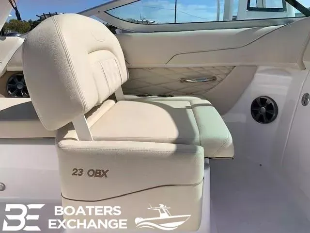 Slide: The Image of Beige interior seating of 2018 Regal OBX boat, featuring "23 OBX" embroidery. - 6