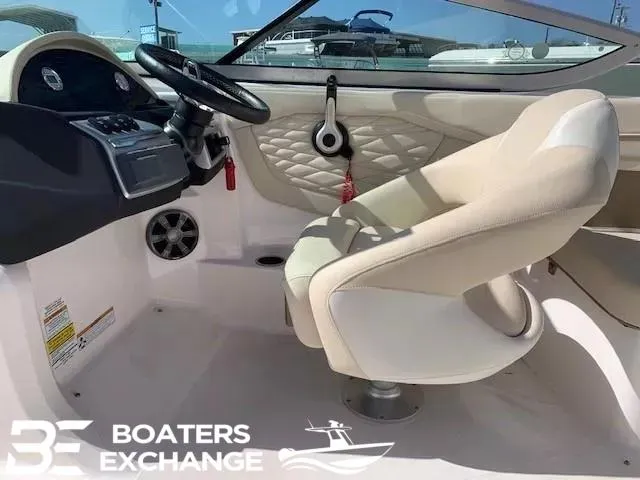 Slide: The Image of Interior of a 2018 Regal OBX boat with beige seating and steering console. - 7