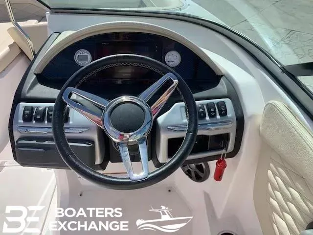 Slide: The Image of Steering wheel of a 2018 Regal OBX boat with dashboard controls. - 8