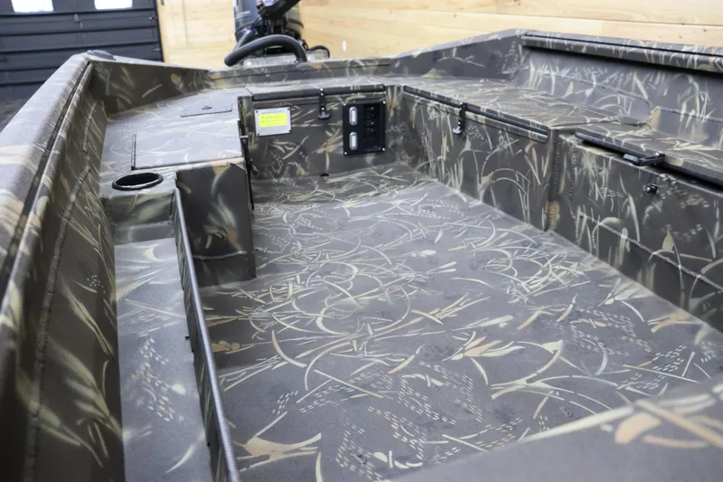 Slide: The Image of 2024 Excel 1651 Viper boat interior with camouflage design and storage compartments. - 16