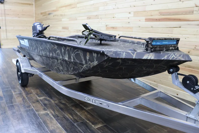 Slide: The Image of 2024 Excel 1651 Viper boat on trailer in showroom. - 2