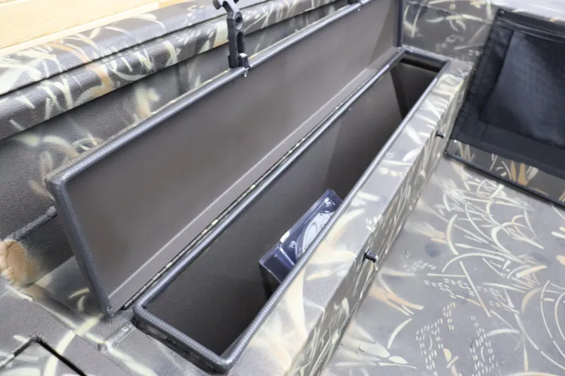 Slide: The Image of 2024 Excel 1651 Viper boat storage compartment with camouflage design. - 23