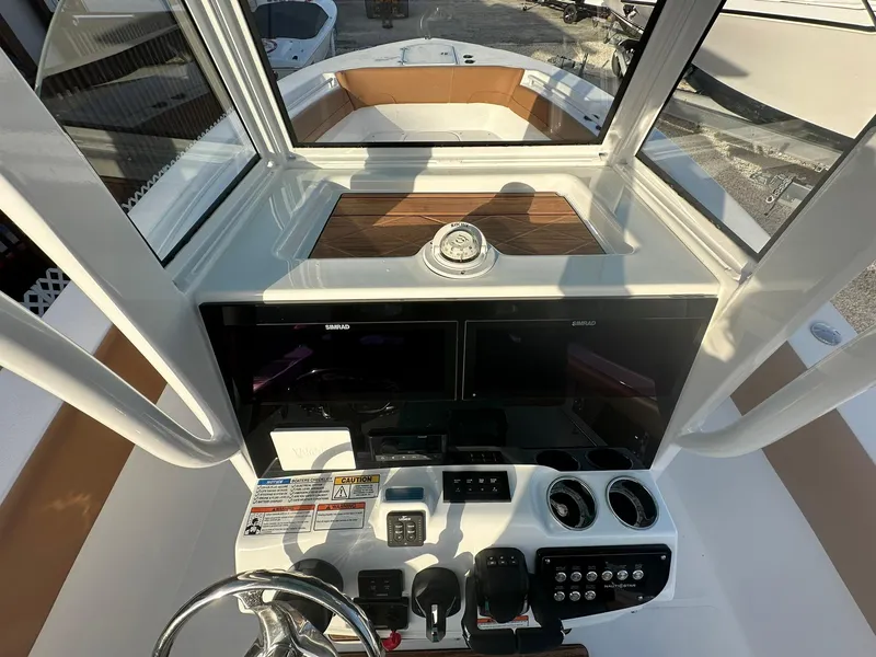 Slide: The Image of 2024 NauticStar 292 Legacy boat helm with modern controls and navigation screens. - 10