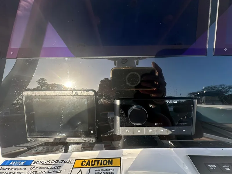 Slide: The Image of Control panel of 2024 NauticStar 292 Legacy boat with Yamaha and Fusion displays. - 17