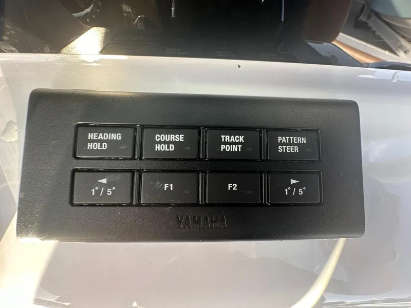 Slide: The Image of Control panel of a 2024 NauticStar 292 Legacy boat with Yamaha navigation buttons. - 19
