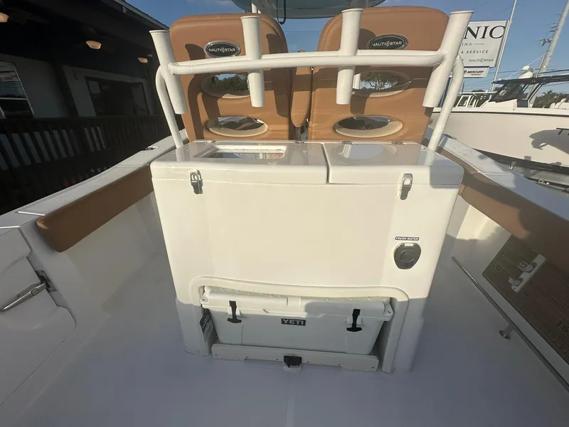 Slide: The Image of 2024 NauticStar 292 Legacy boat interior with seating and storage. - 24