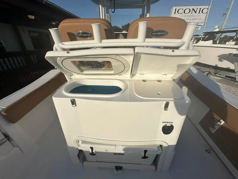 Slide: The Image of 2024 NauticStar 292 Legacy boat interior with open storage compartments. - 25