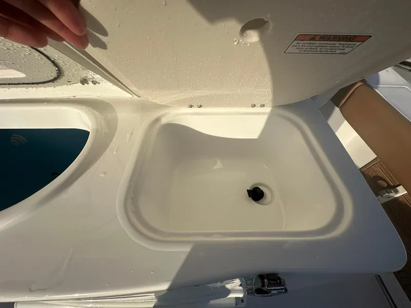 Slide: The Image of NauticStar 292 Legacy 2024 boat sink and storage compartment. - 26