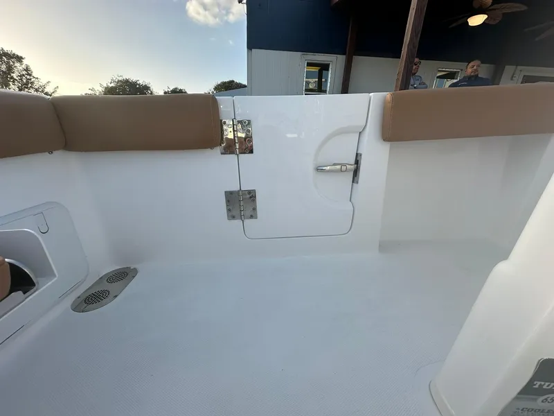 Slide: The Image of 2024 NauticStar 292 Legacy boat interior with white deck and tan seating. - 28