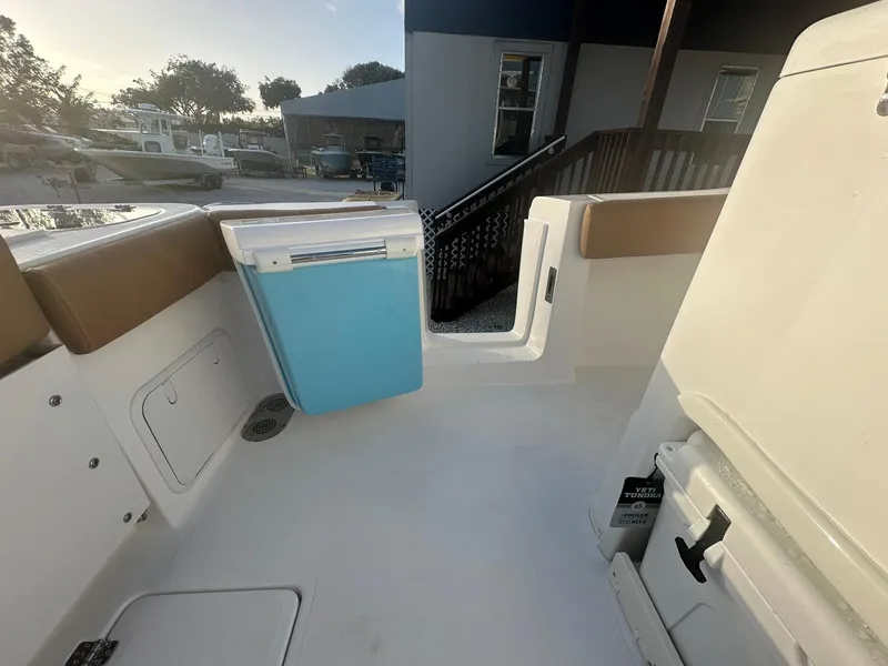 Slide: The Image of 2024 NauticStar 292 Legacy boat interior with seating and storage compartments. - 29