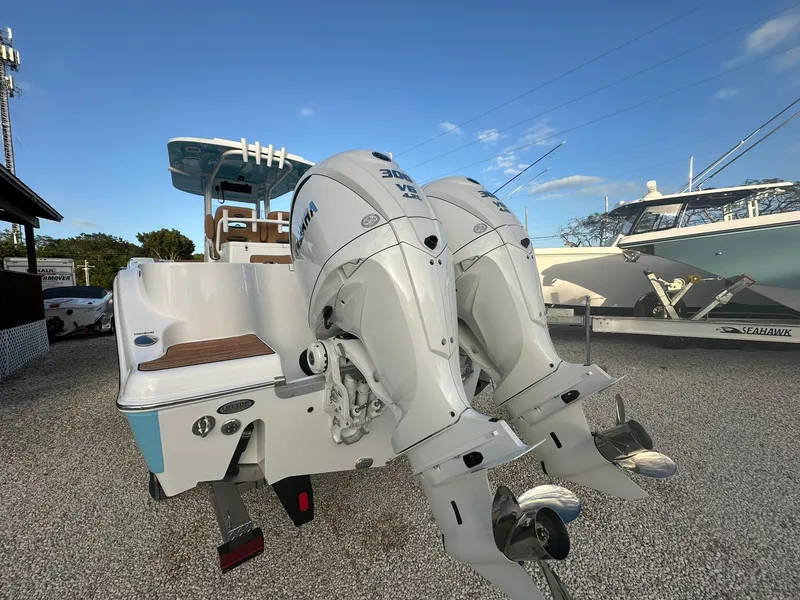 Slide: The Image of 2024 NauticStar 292 Legacy boat with twin outboard engines. - 3