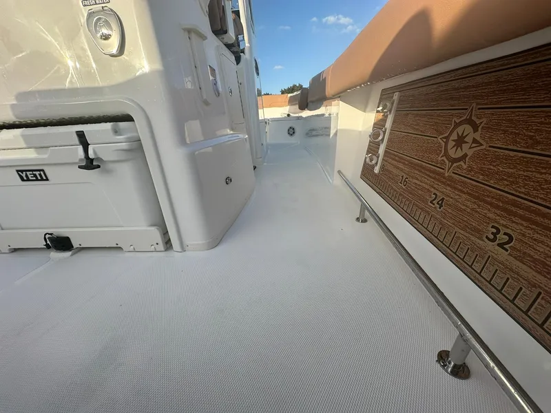 Slide: The Image of 2024 NauticStar 292 Legacy boat deck with Yeti cooler and fish ruler. - 32