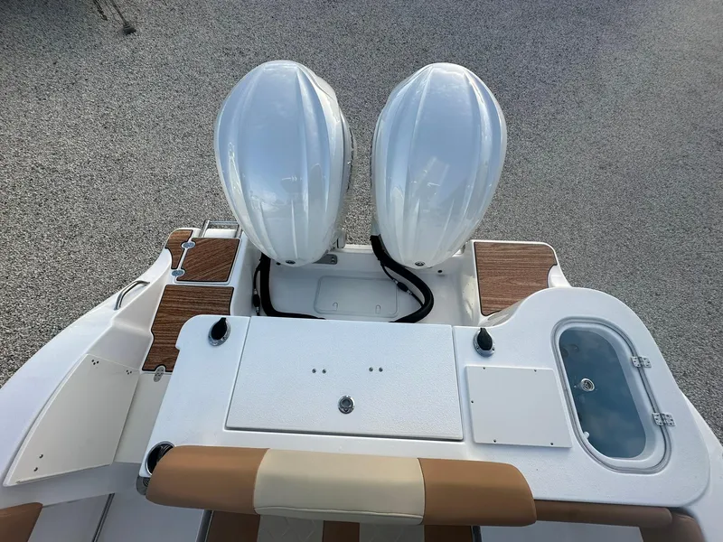 Slide: The Image of 2024 NauticStar 292 Legacy boat with twin outboard engines and deck features. - 33