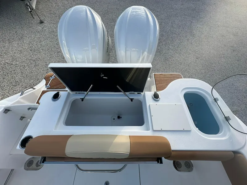 Slide: The Image of 2024 NauticStar 292 Legacy boat with dual engines and open storage compartments. - 34