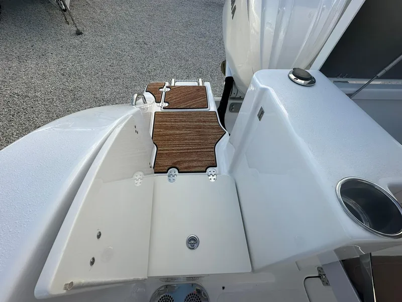 Slide: The Image of 2024 NauticStar 292 Legacy boat deck with wood accents and storage compartments. - 36