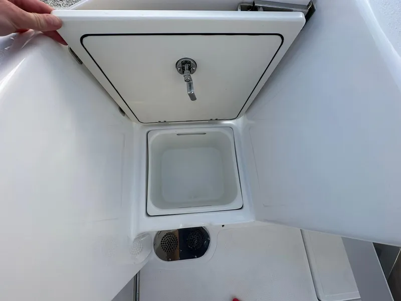 Slide: The Image of 2024 NauticStar 292 Legacy boat storage compartment with lid open. - 37