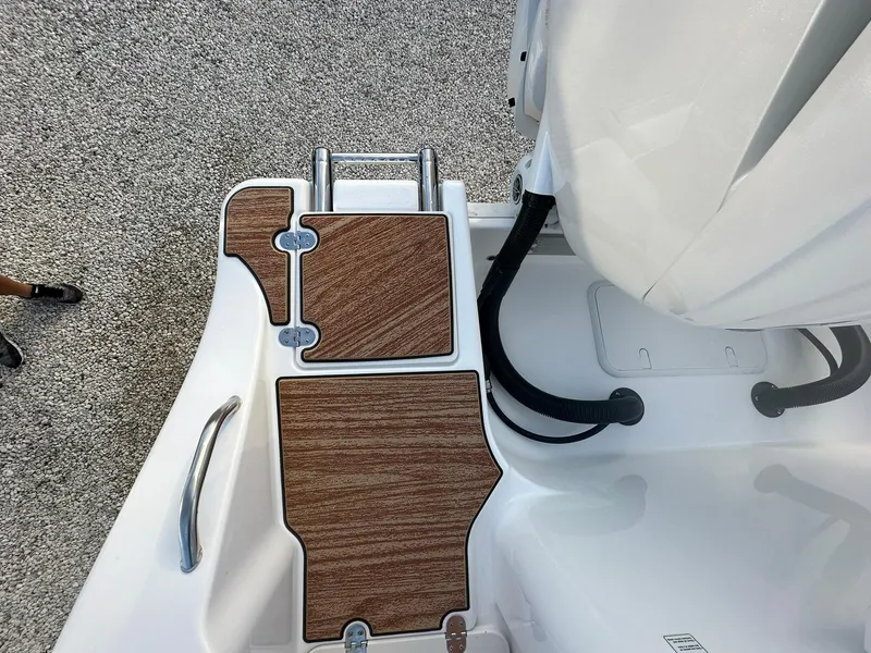 Slide: The Image of 2024 NauticStar 292 Legacy swim platform with teak-style decking and retractable ladder. - 38