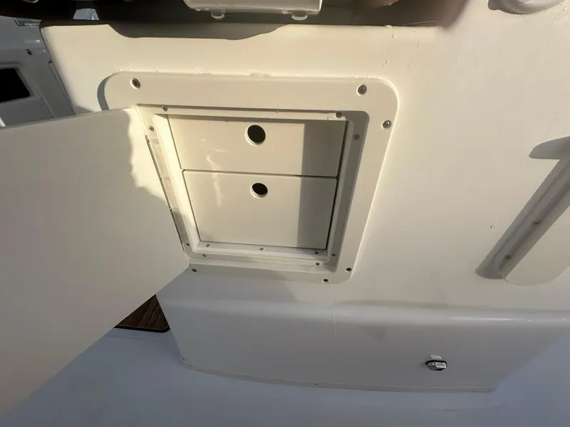 Slide: The Image of 2024 NauticStar 292 Legacy storage compartment with open door. - 41